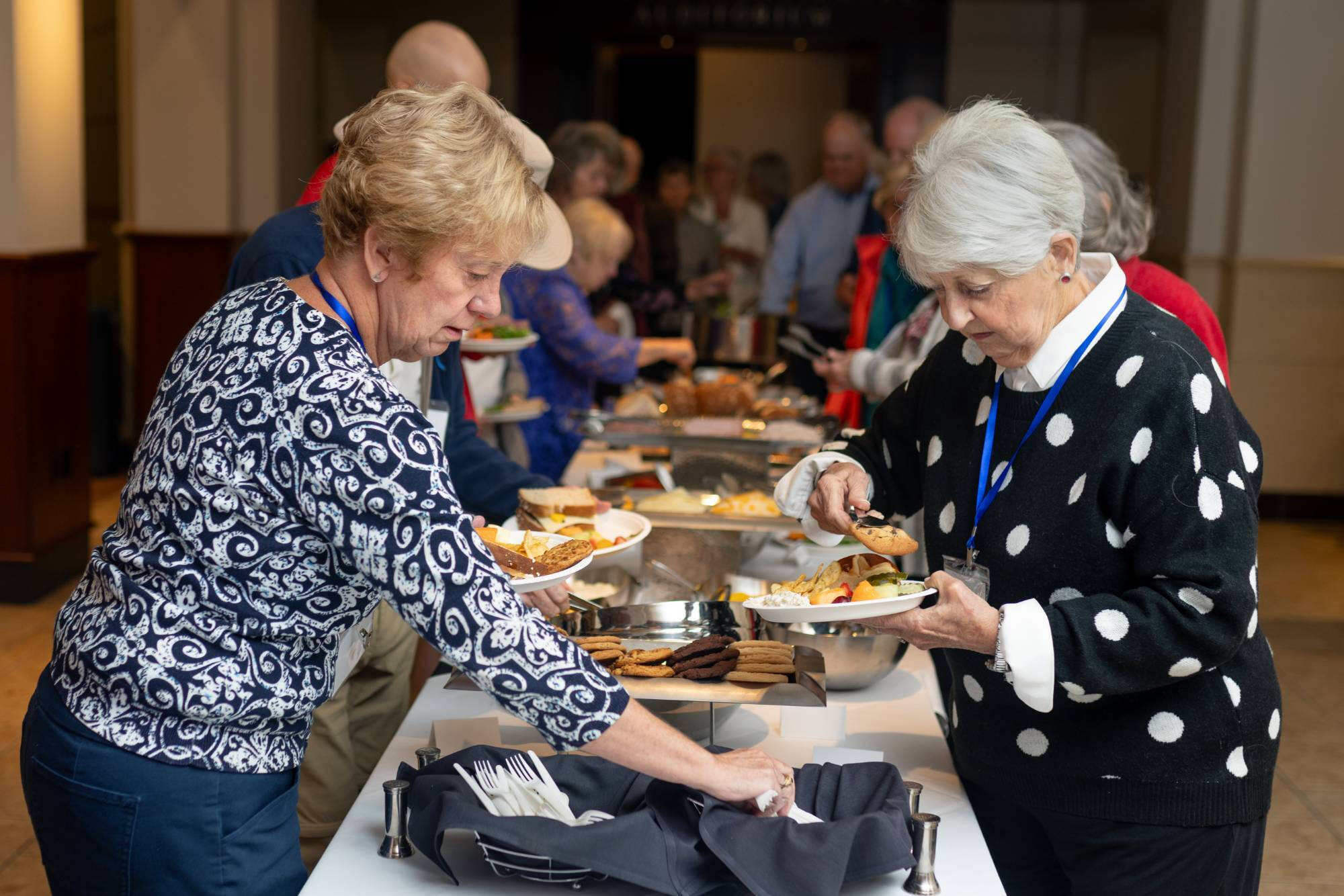 Grand Forum attendees prepare plates during lunch.